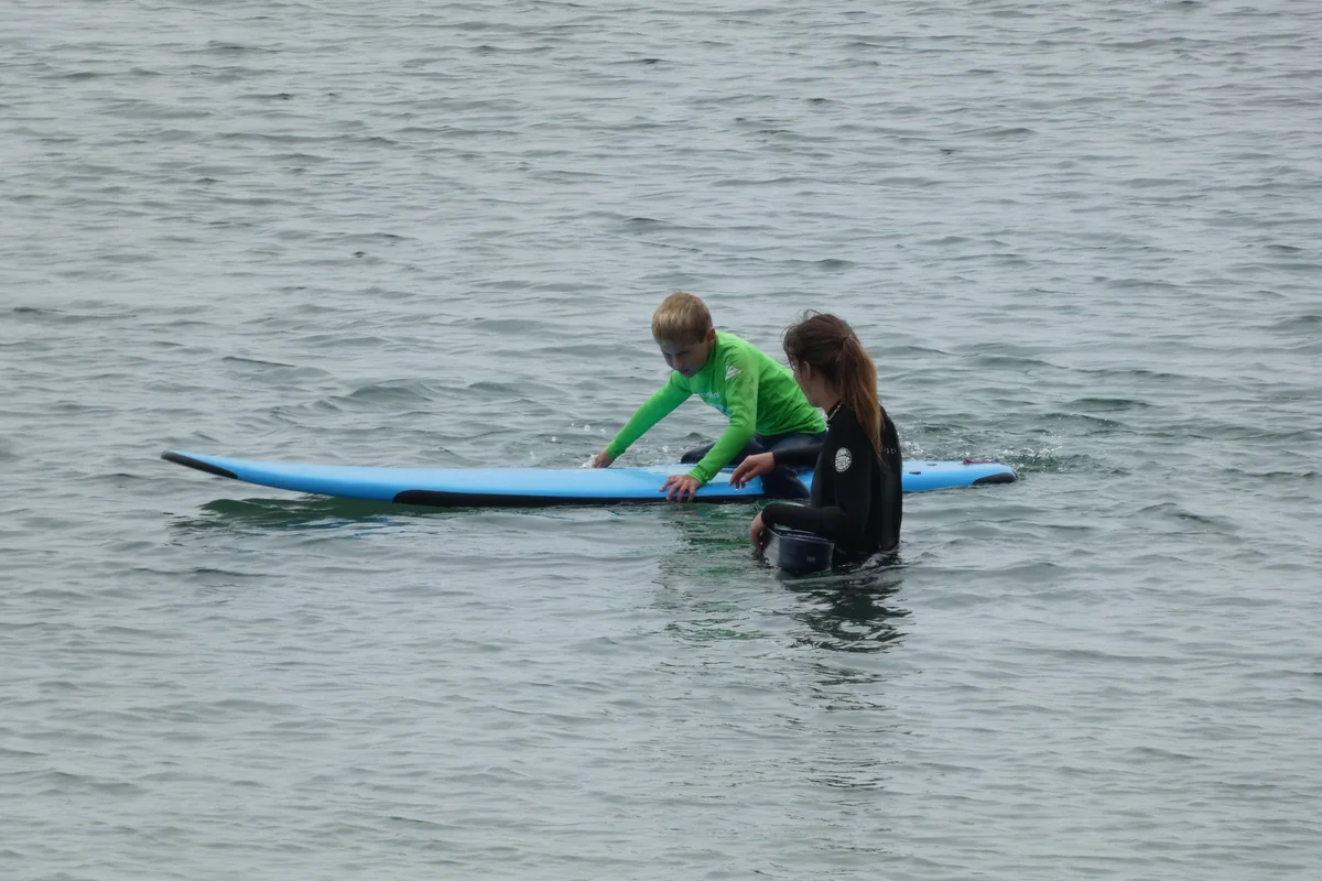 A beginner surf lesson in the whitewater (representative)